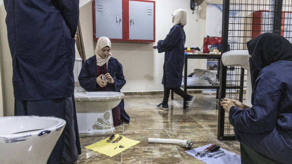 Students practice their skills during a workshop at Safaa's training academy.