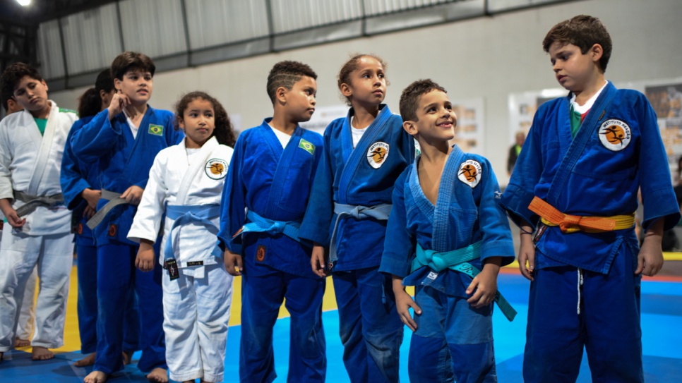 Young Brazilians at the judo training centre look in admiration at Olympians Yolande and Popole.