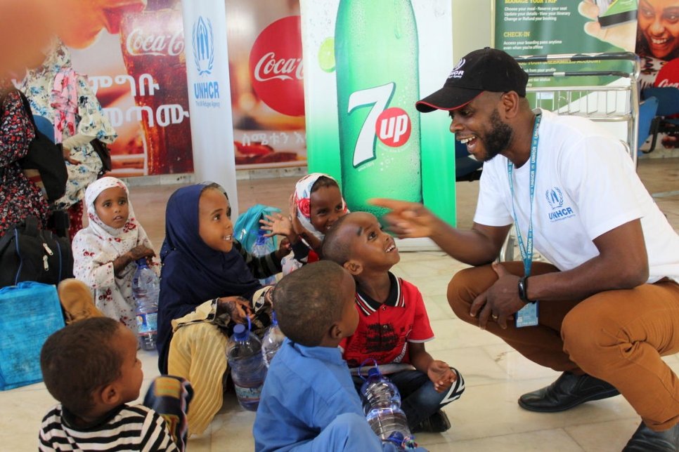 Louis Lithur, the head of UNHCR's office in Jijiga, laughs with a group of children who have just arrived in Dire Dawa, Ethiopia. 