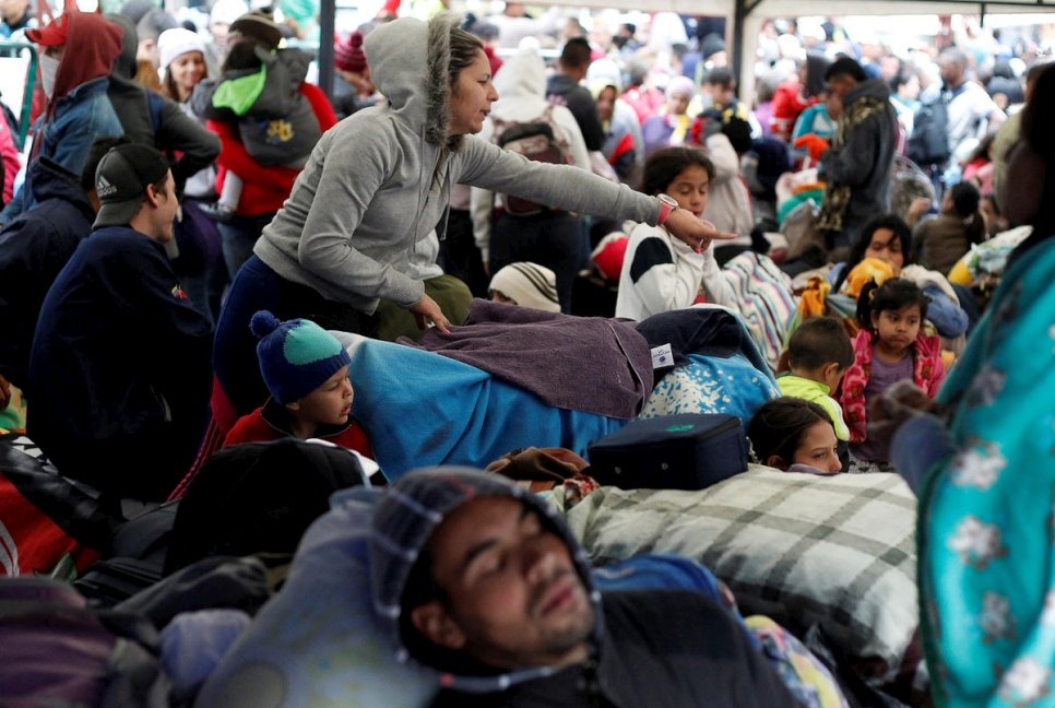 Colombia. Fleeing Venezuelans wait to register their exit from Colombia before entering into Ecuador, at the Rumichaca International Bridge.