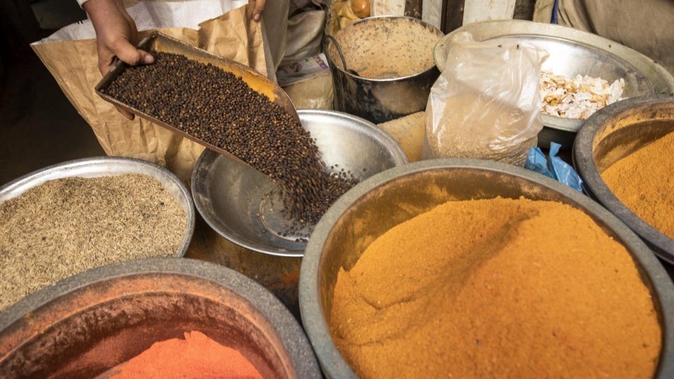Mohammad refills his spices at his shop in Al-Asif Square market, Karachi.