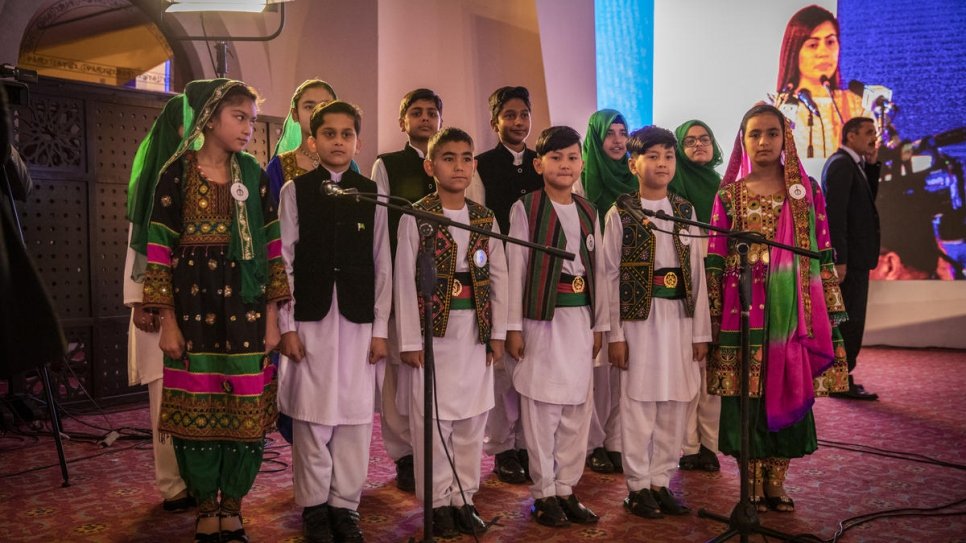 Afghan and Pakistani children in traditional national dress sing the national anthems of both countries at the start of the Refugee Summit in Islamabad.
