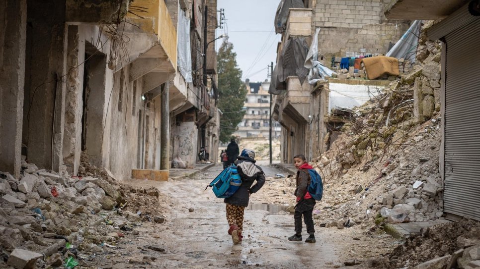 Civilians displaced by Syria's conflict pick through the ruins of their homes after returning to the northern city of Aleppo. 