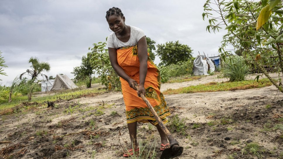 Angelina, 31, works on the piece of land the government attributed to her and her husband in Mutua settlement.