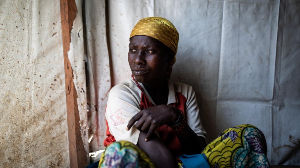 Vumuli, 35, sits outside a church being used as a temporary shelter for internally displaced persons in Drodro, Ituri Province in the Democratic Republic of the Congo. 