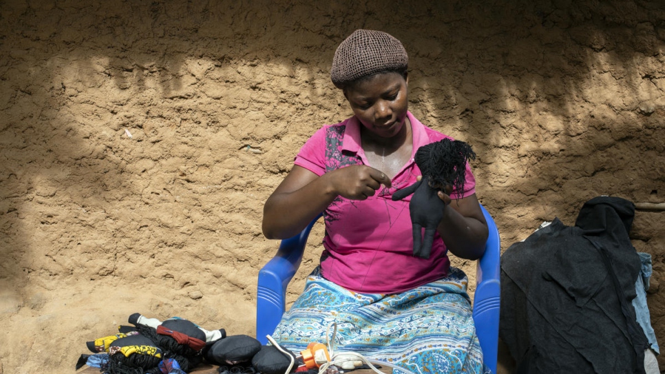 Congolese refugee Kituza, 25, finds healing with each doll she makes in Maratane refugee camp, Mozambique.