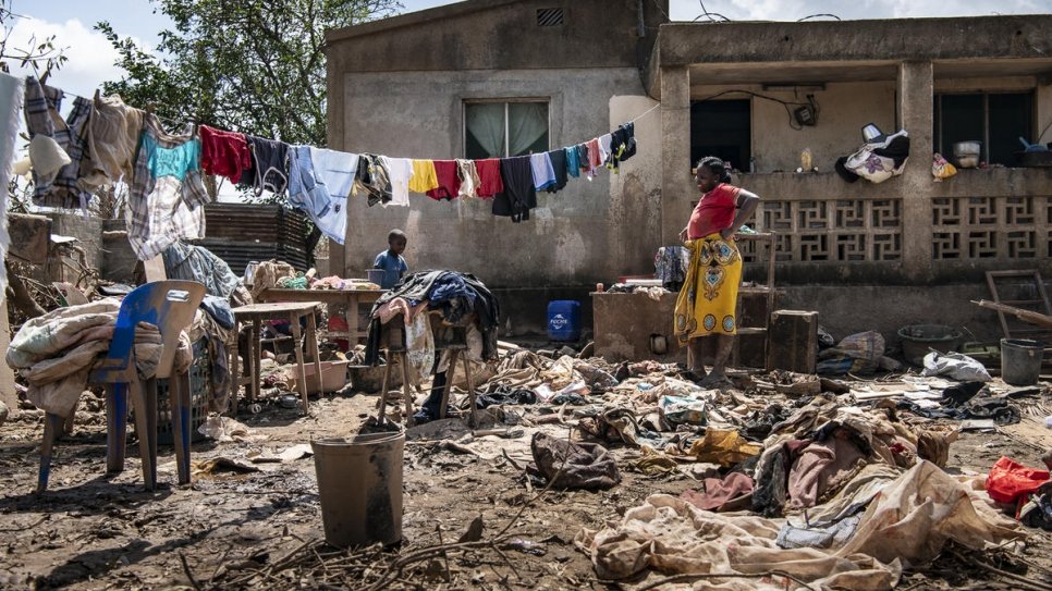 A family spreads their household belongings in the front yard to dry after Cyclone Idai's rampage through Buzi, Mozambique.