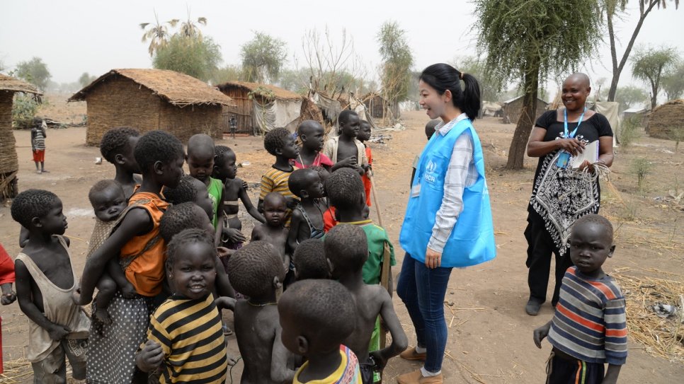 UNHCR communications officer Eujin Byun talks to refugee children at a camp in South Sudan.