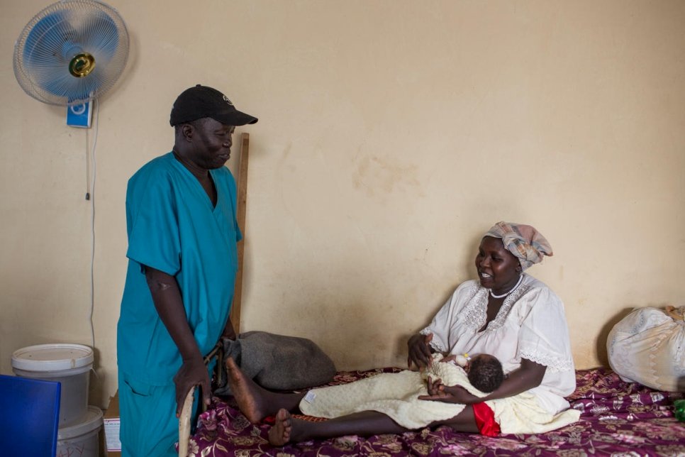 Dr. Evan Atar Adaha talks to a patient from Sudan, Gisma Al Amin, in the maternity ward of Bunj Hospital in Maban County, South Sudan. 