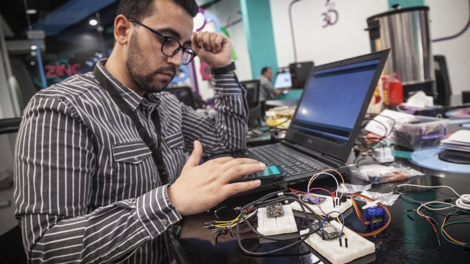 Ehab configures sensors sold by his company, Drag IOT, which measure changes in temperature and humidity.