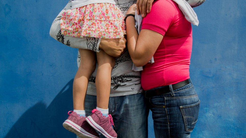 A family from Nicaragua wait to file their asylum application at the immigration office in San Jose, Costa Rica.