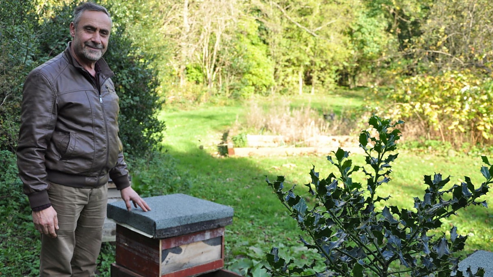 ​Ryad Alsous with one of his hives in the orchard at Armitage Bridge, Yorkshire.