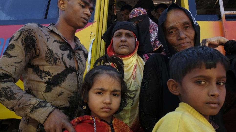 Rohingya refugees alight from a bus at the UNHCR registration and distribution centre in Kutupalong settlement, Bangladesh.