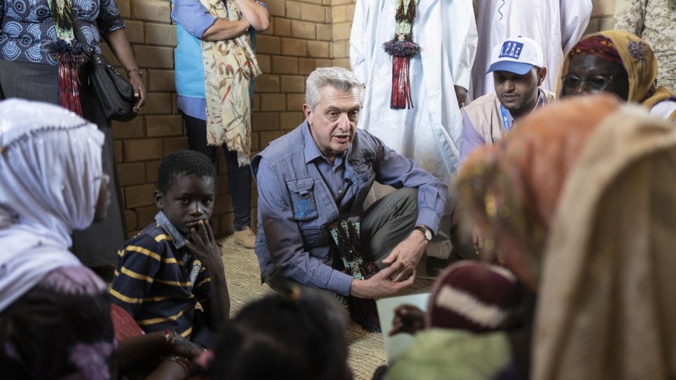 UN High Commissioner for Refugees Filippo Grandi speaks with Kadi Oumar, the widowed head of a household of nine, in her new home.