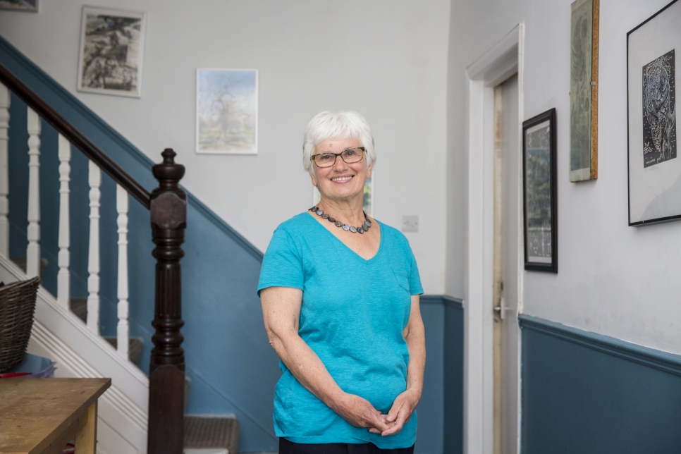 Kathy Galashan stands in the hallway of her London home