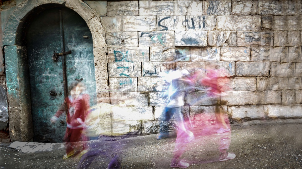 In this photograph of kids playing together in Mosul, Ahmed emulates the style of his hero, American photographer Michael Shainblum.