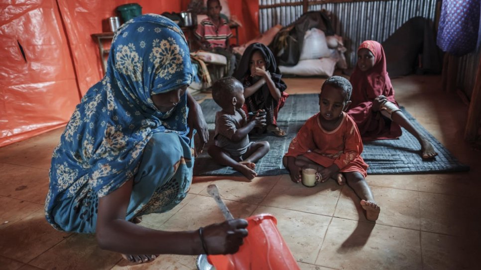 A Somali refugee woman feeds her children at a World Vision's school used as a temporary shelter in Bur Amino, Ethiopia.