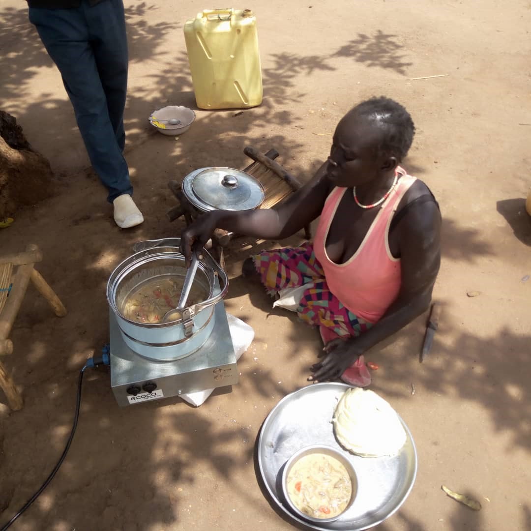 A disabled woman cooking using a solar cooker