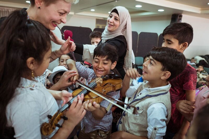 Children testing musicians violin