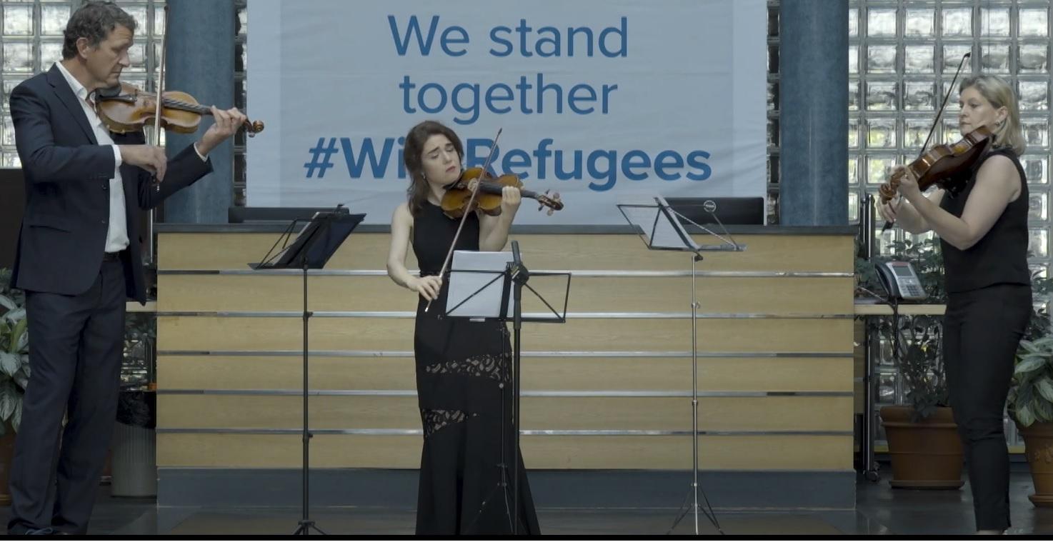 Three musicians playing in the UNHCR atrium