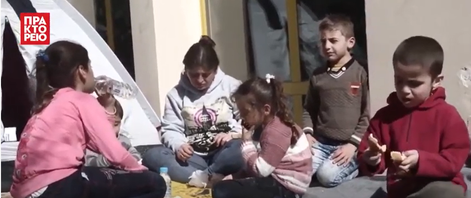 Children sitting on the ground.