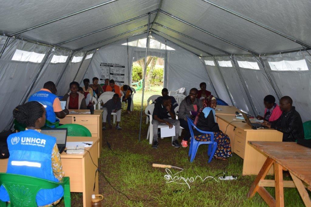 A group of people sitting in a tent 