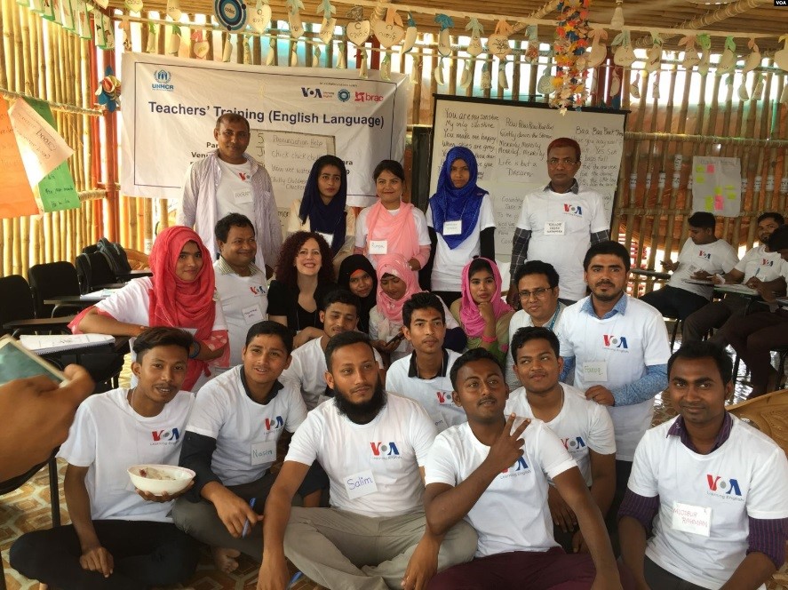 Group of people at a classroom setting in a camp. 