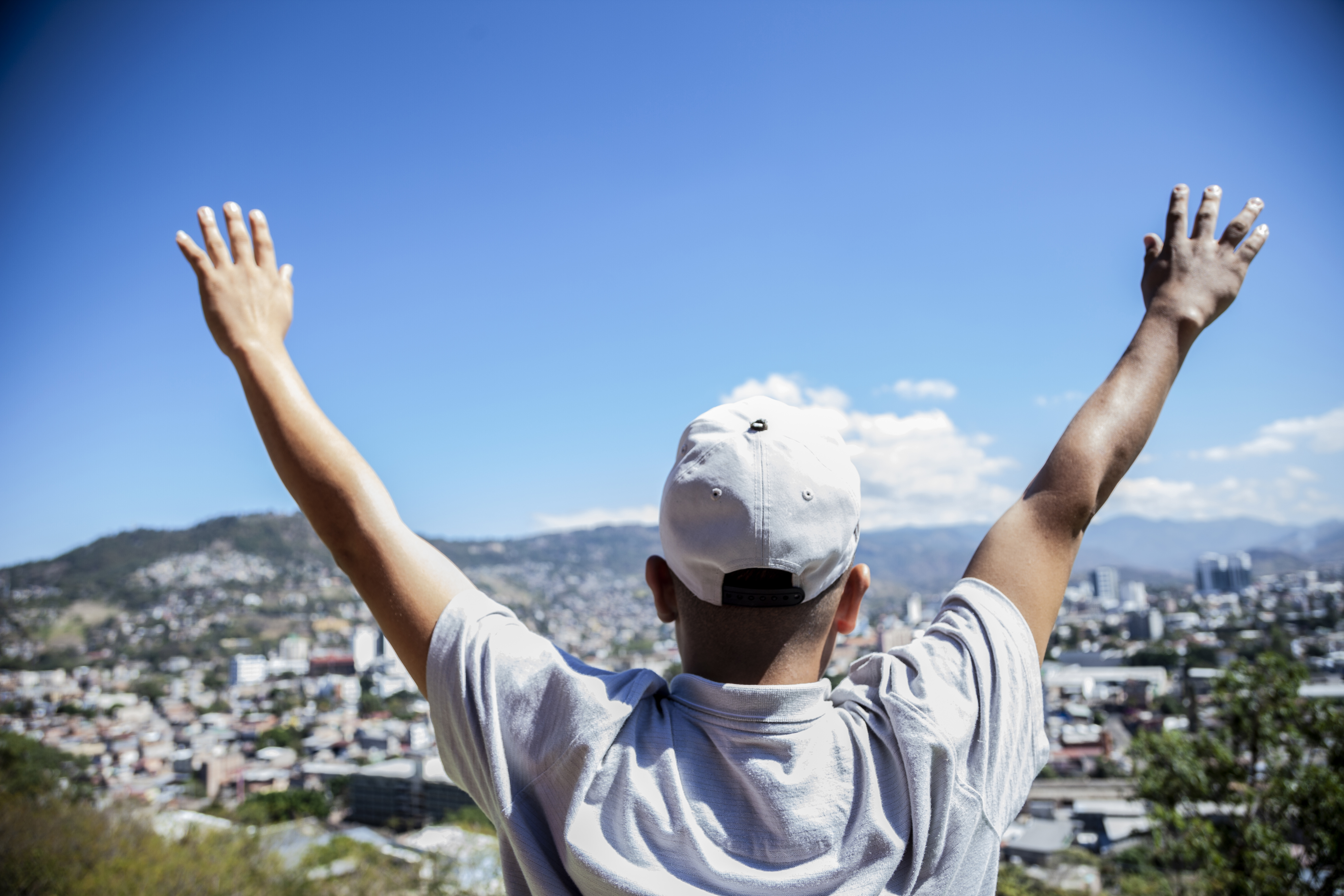 Honduras. A boy looks at a city view.