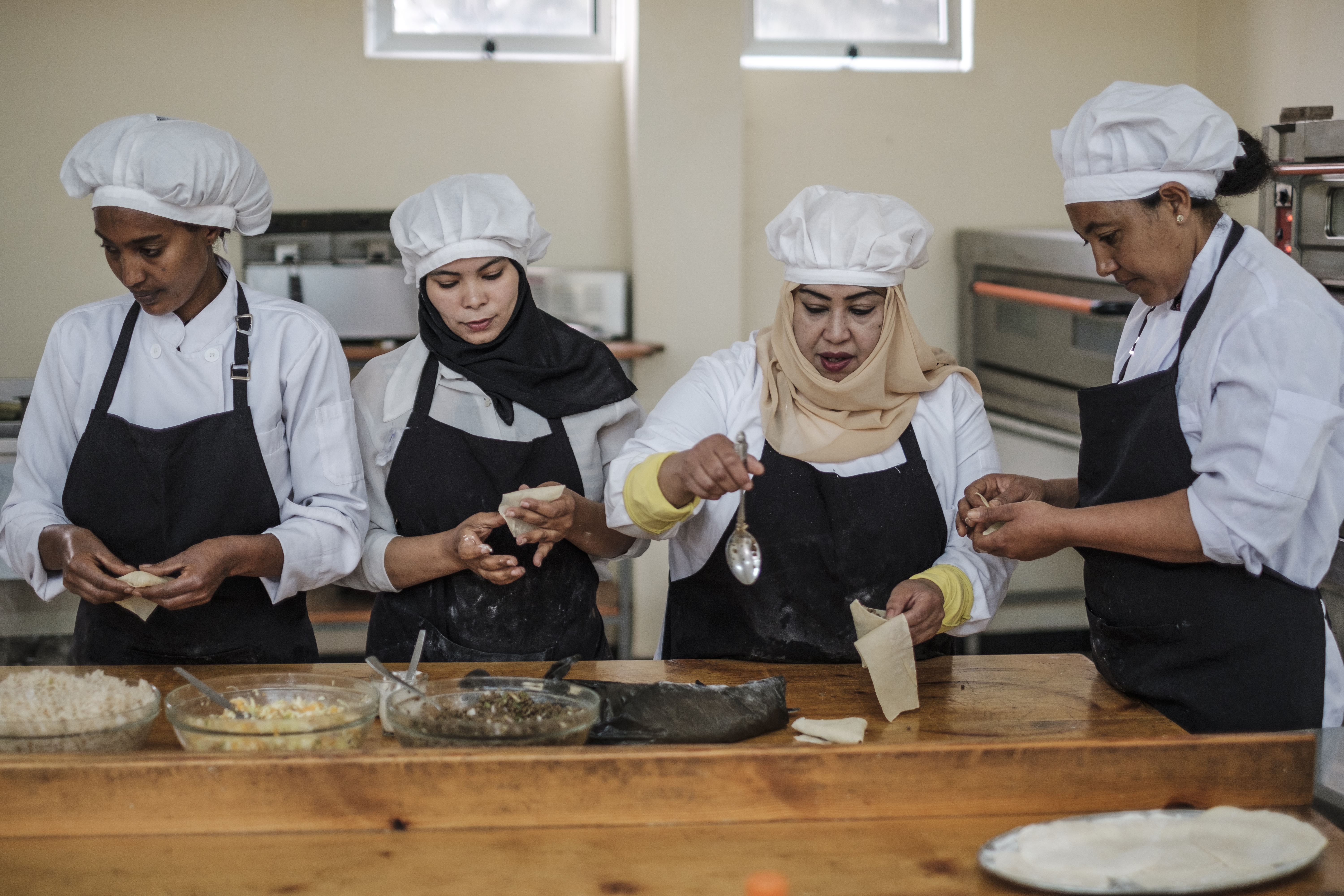 Four chefs prepare food