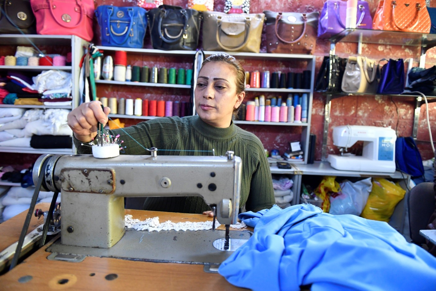 Woman working with a sowing machine.