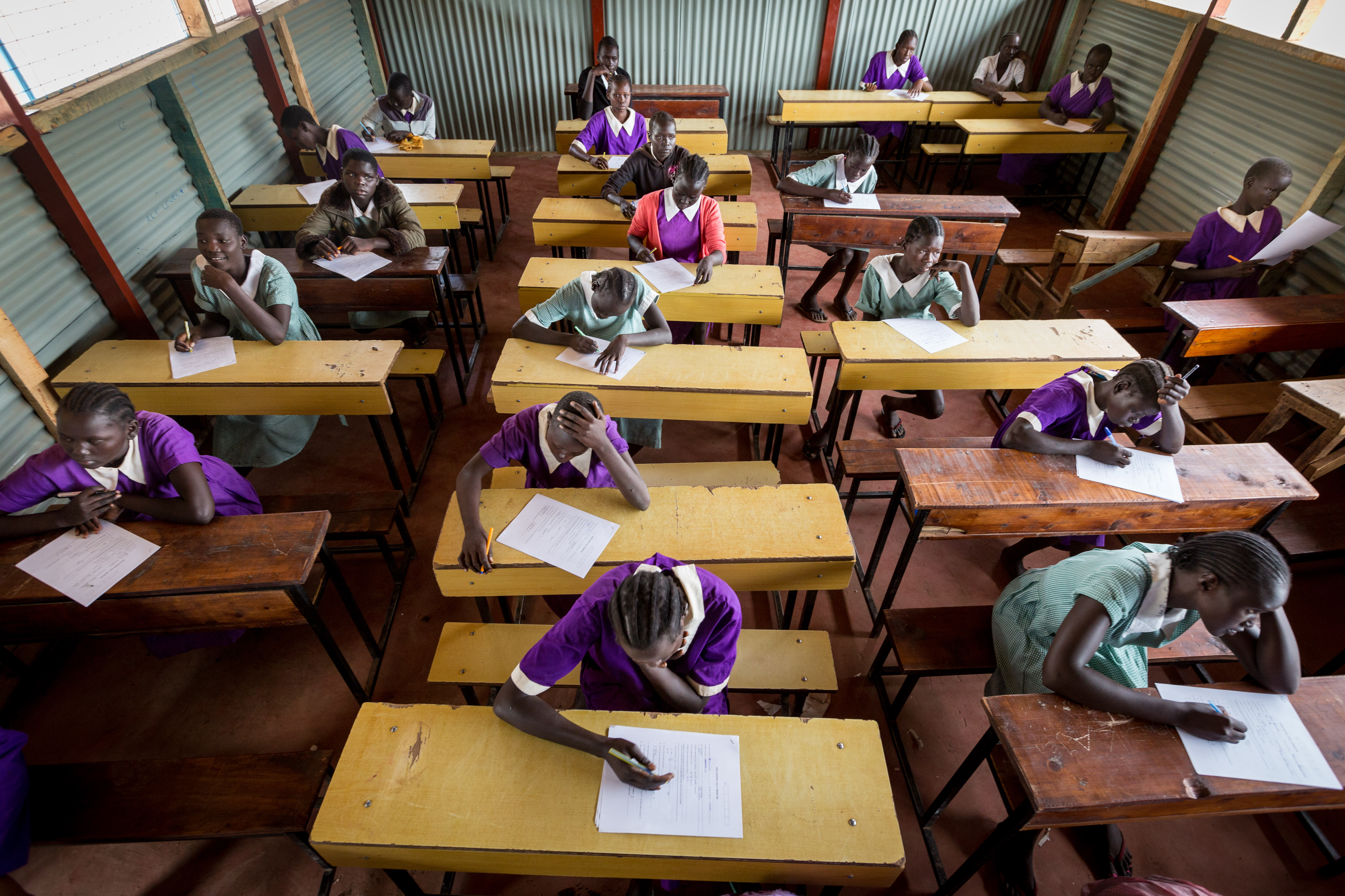 Group of girls sitting at their desks in a classroom studying