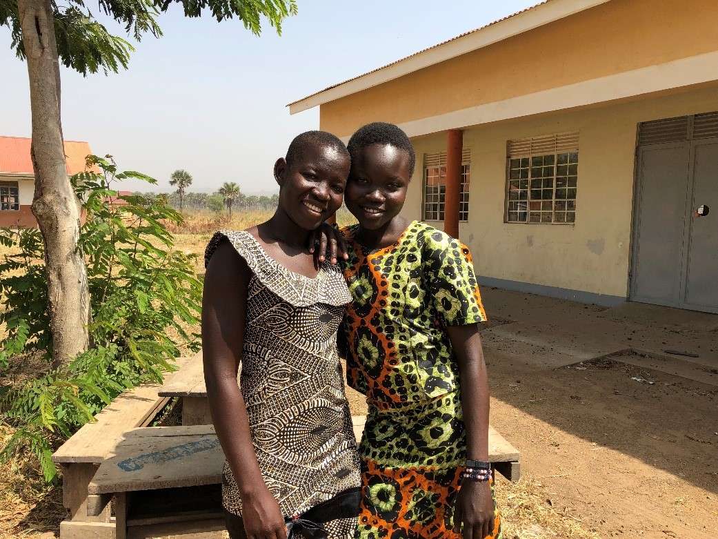 Two girls look at the camera and smile