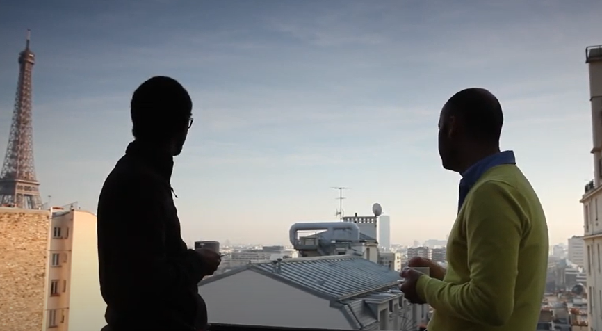 Two man standing looking at the horizon.