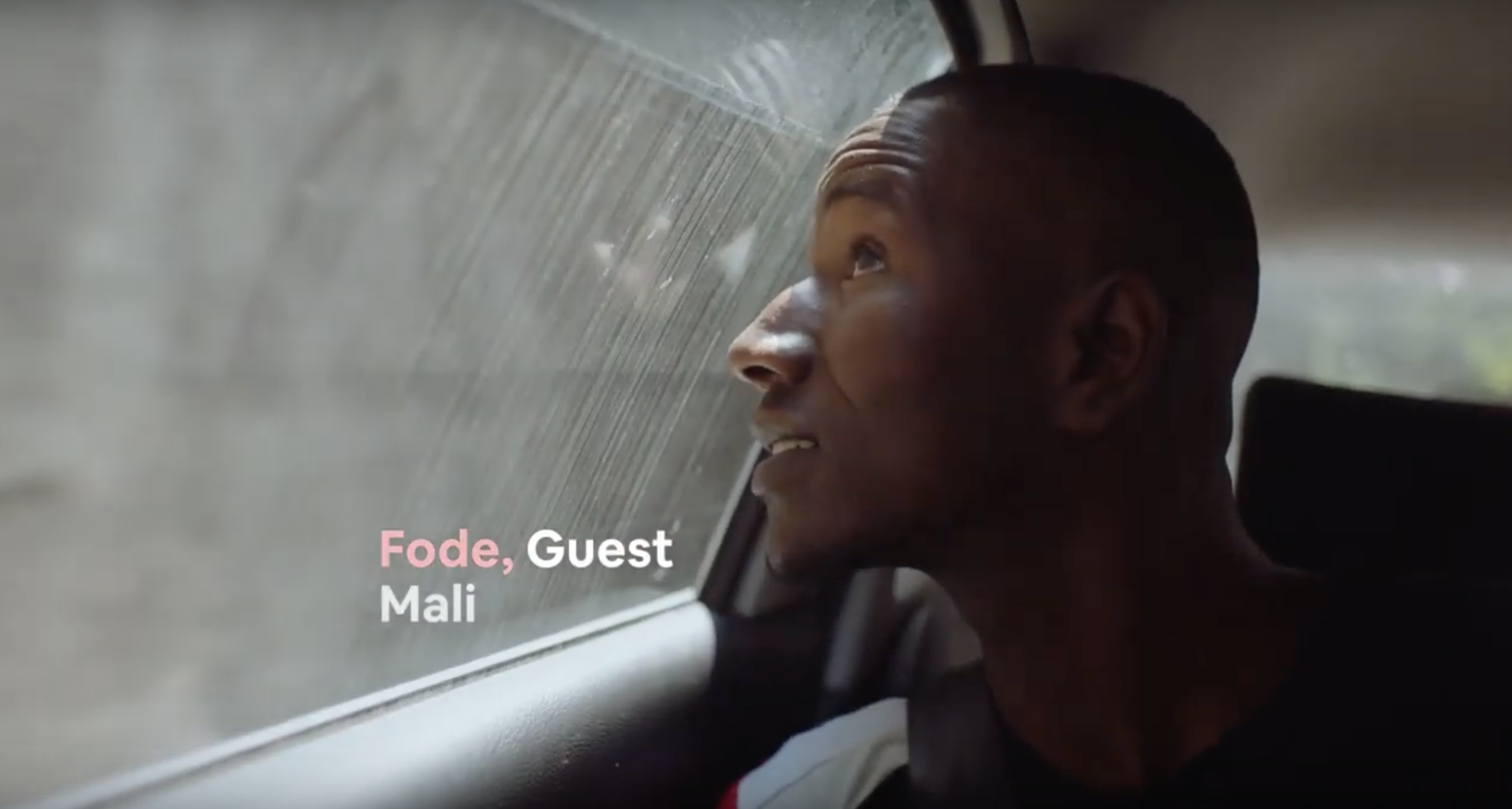 A young man looks out of a car window