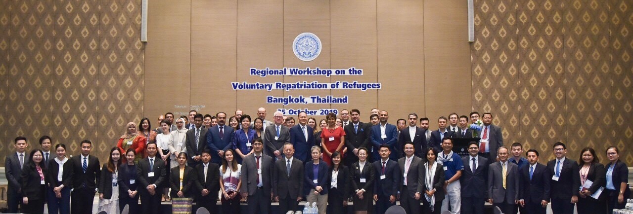 Large group of people posing for a picture in a podium.