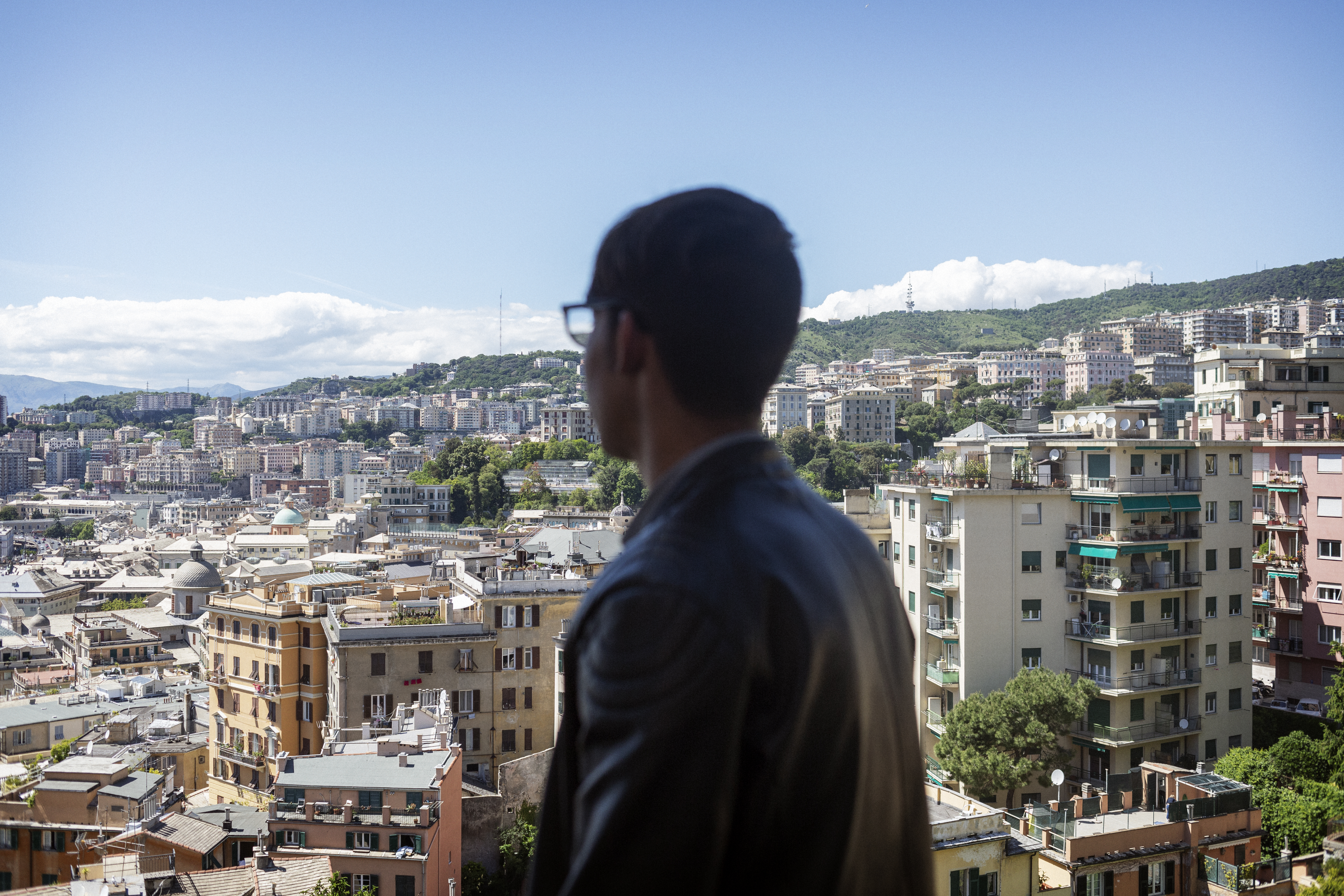 A boy looks out over a city