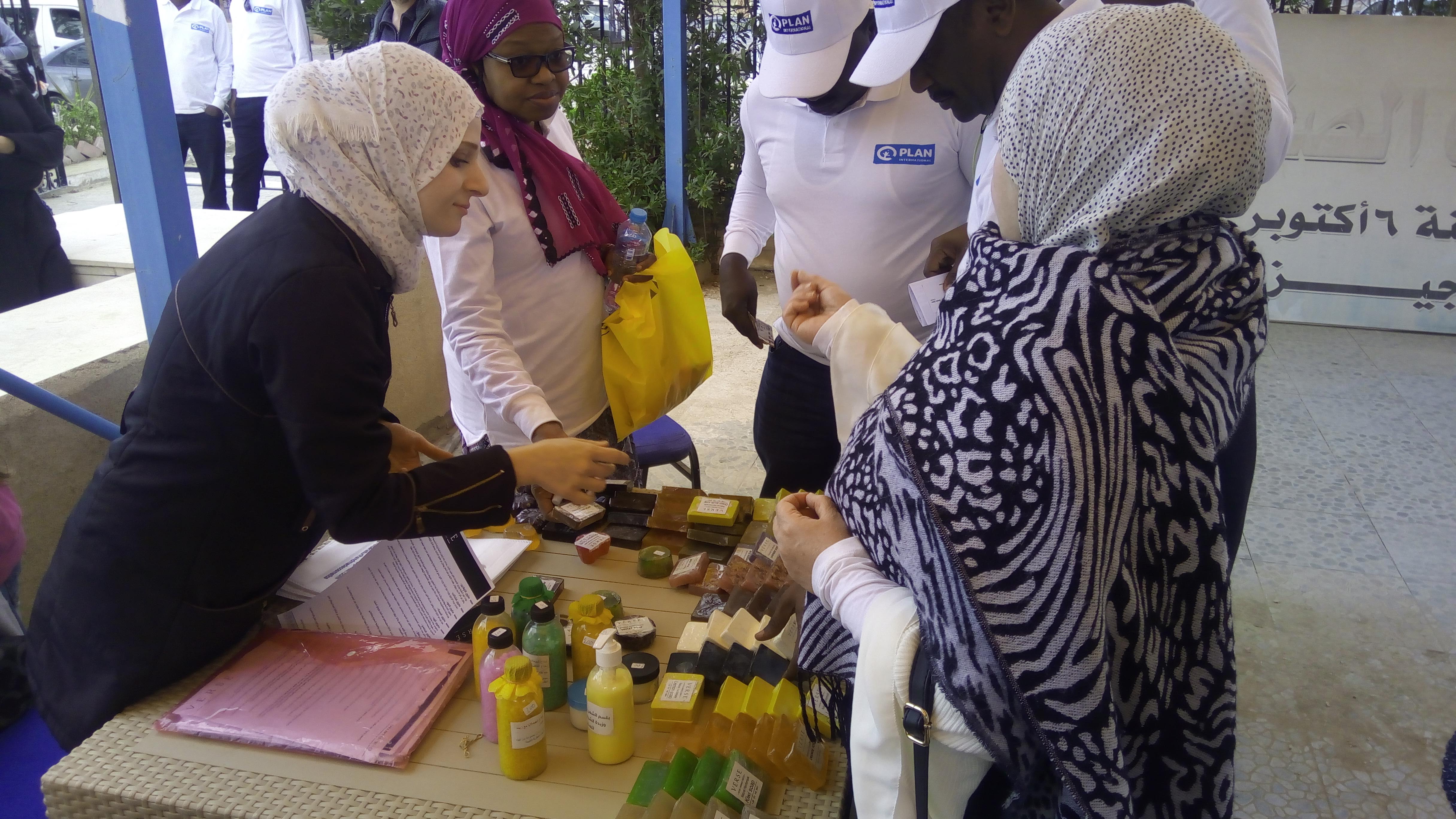 Women around a table selling soap.