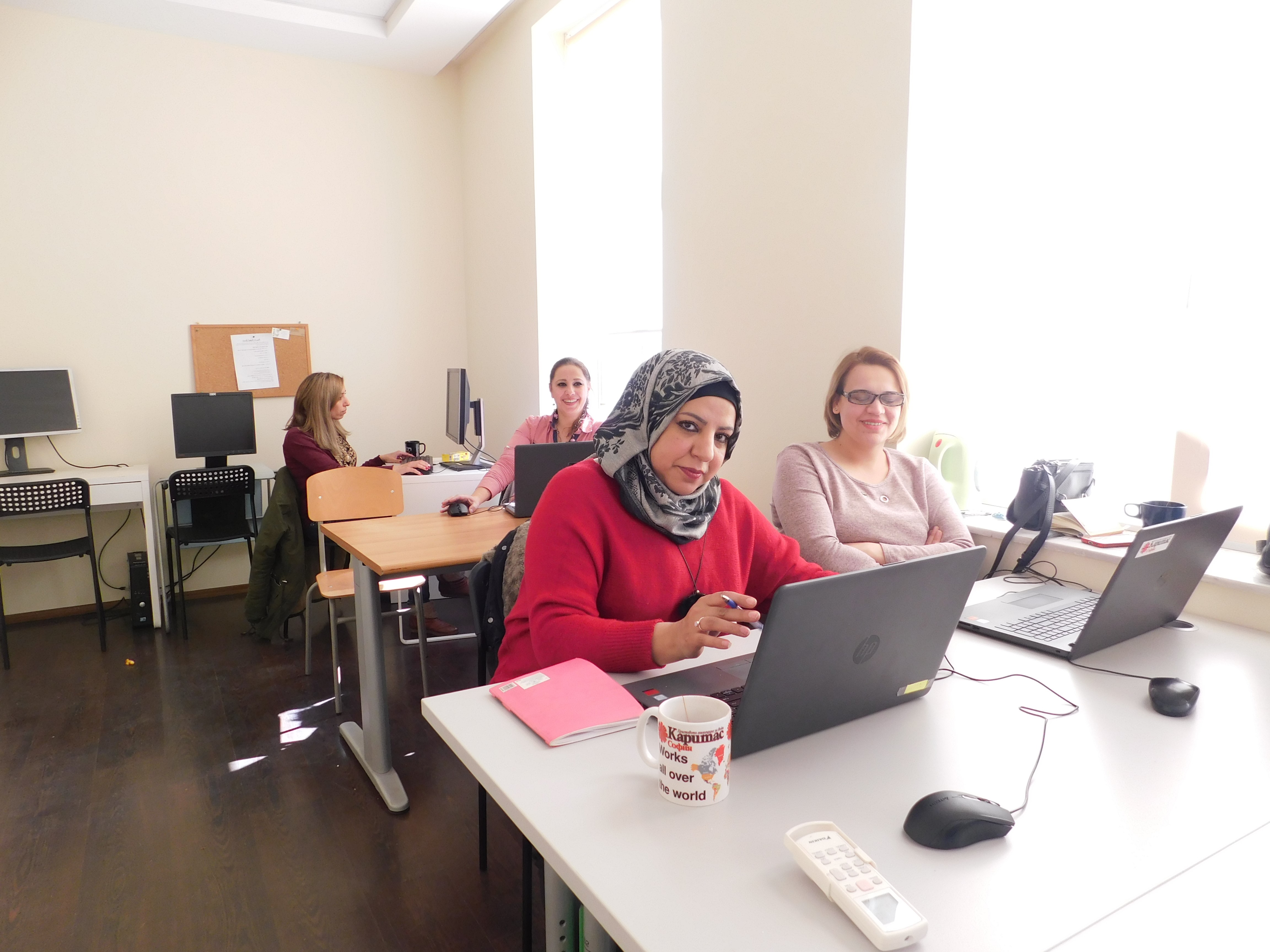 Women with laptops in a classroom.