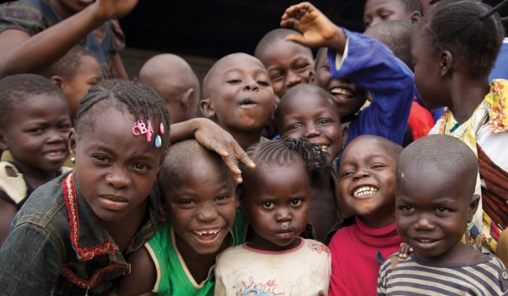 Group of children smile at the camera