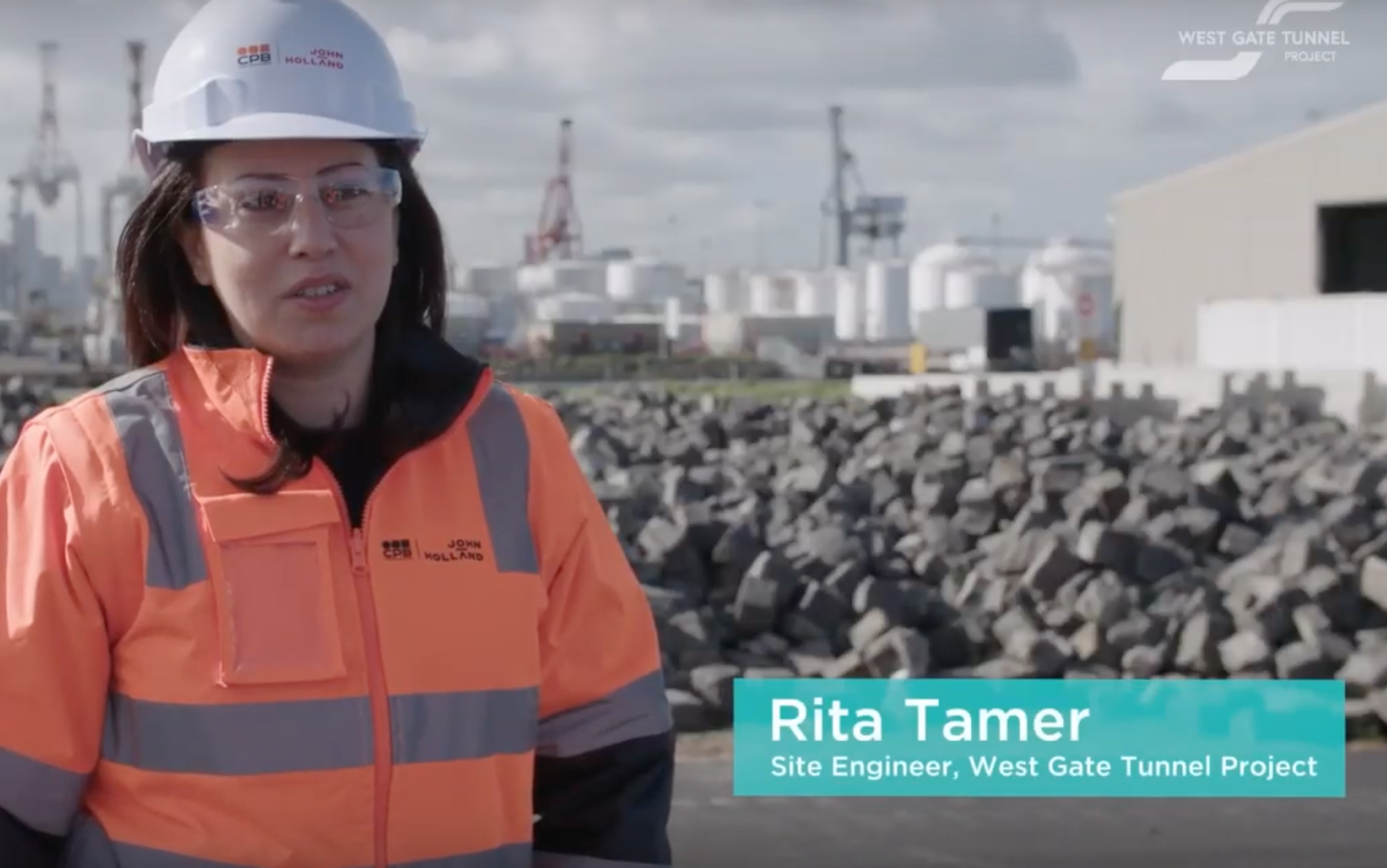 Still frame. A woman on a building site talks to camera