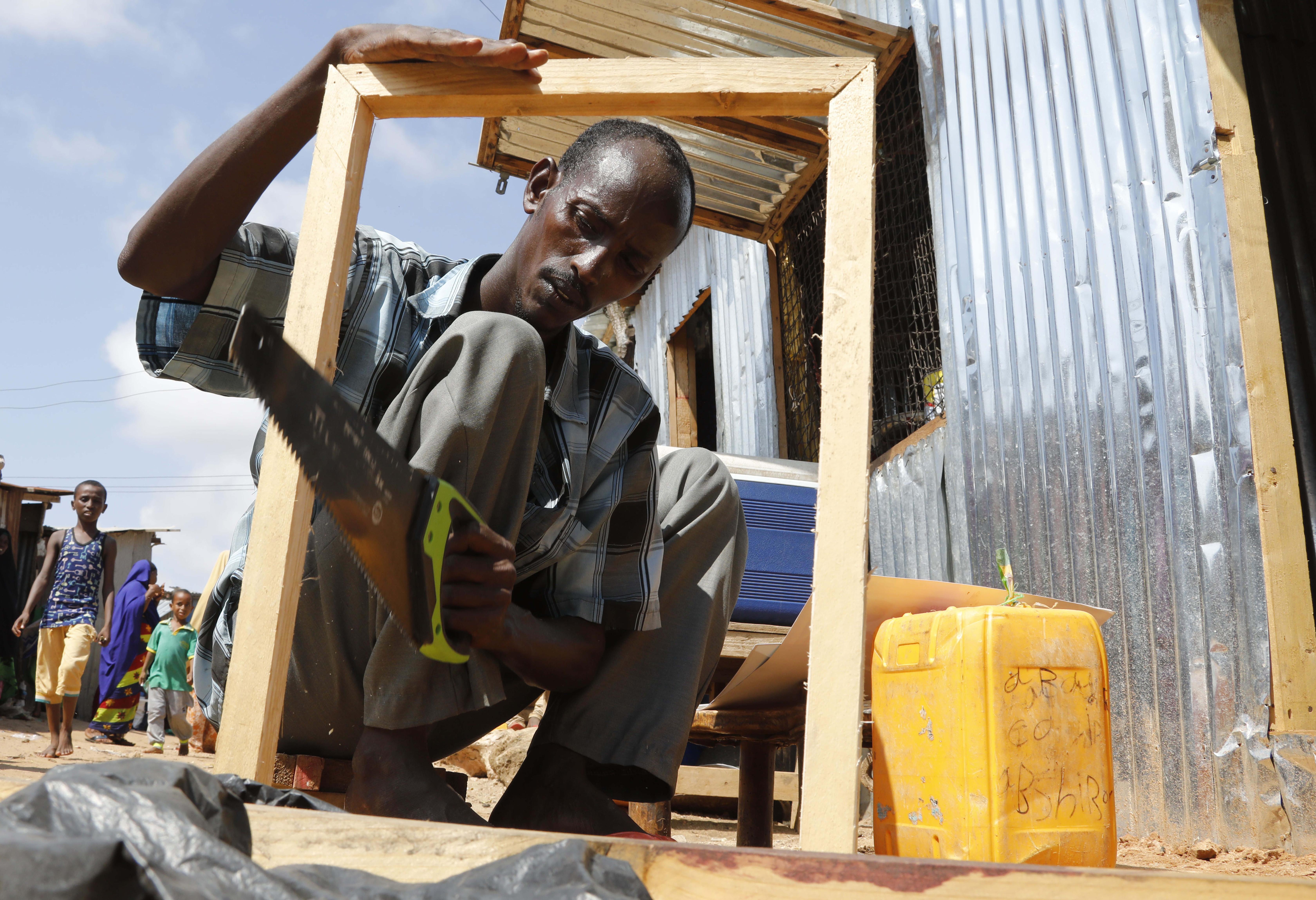 A man makes a wooden picture frame