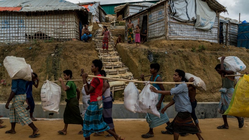 Rohingya refugees move out of an area at risk from landslides in Camp 5 to a newly built extension site in Camp 4, Kutupalong, Bangladesh.
