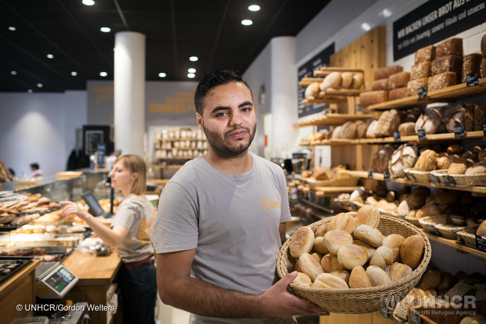 Mohamad Hamza Alemam at work among the baked goods at Backwerkstatt bakery and cafe. Bakery owner Björn Wiese, 46, from the bakery Backwerkstatt in Eberswalde, eastern Germany, is transforming lives by providing training and prospects to refugees.