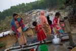 Une famille de Rohingyas récemment arrivés remplit des seaux avec de l'eau tirée d'un puits dans un site de fortune à Cox's Bazar, au Bangladesh, où des dizaines de milliers de réfugiés vivent depuis une flambée antérieure de violences au Myanmar en octobre 2016. 