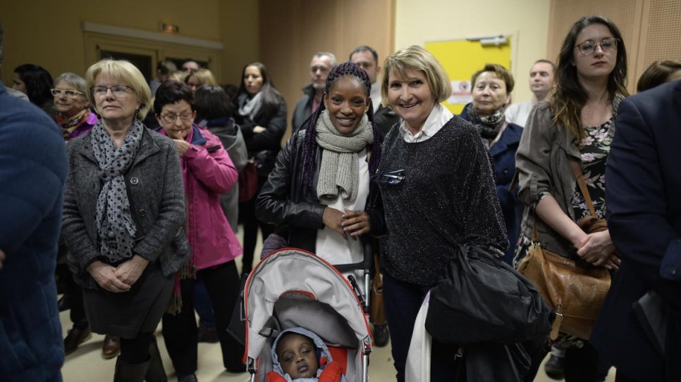 Refugees and locals celebrate the new year at a buffet in Pessat-Villeneuve.