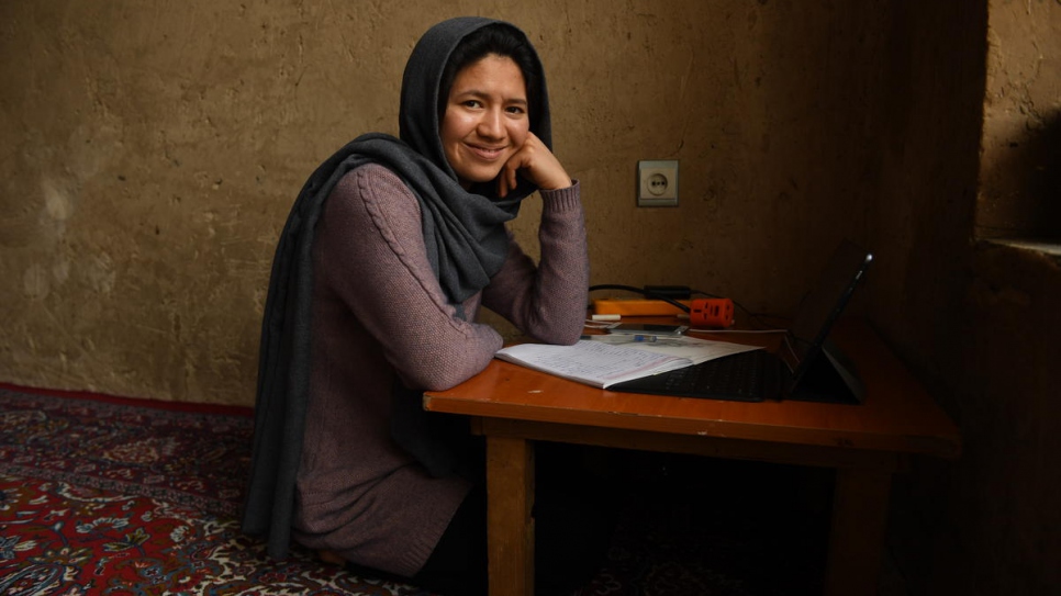 Twenty-seven-year-old Afghan returnee Kobra Yusufy is photographed at home in her living room in Kabul, Afghanistan.