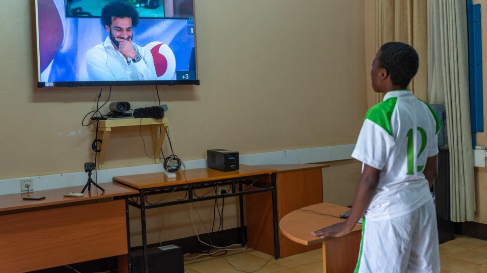 Bitisho Bugoma, a football player with Kakuma Stars, an all-girls refugee football team from Democratic Republic of the Congo, asks a question of football star Mohamed Salah. Young refugees watched Salah on Tuesday from Kakuma refugee camp in Kenya.