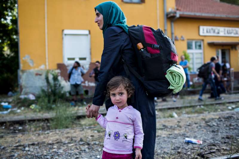 Syrian refugees wait for a train at the station in Demir Kapija, Macedonia, in June 2015.