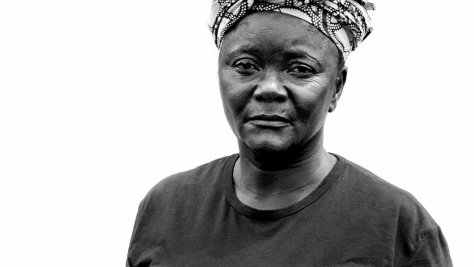 Black-and-white portrait of a Congolese refugee woman facing the camera.