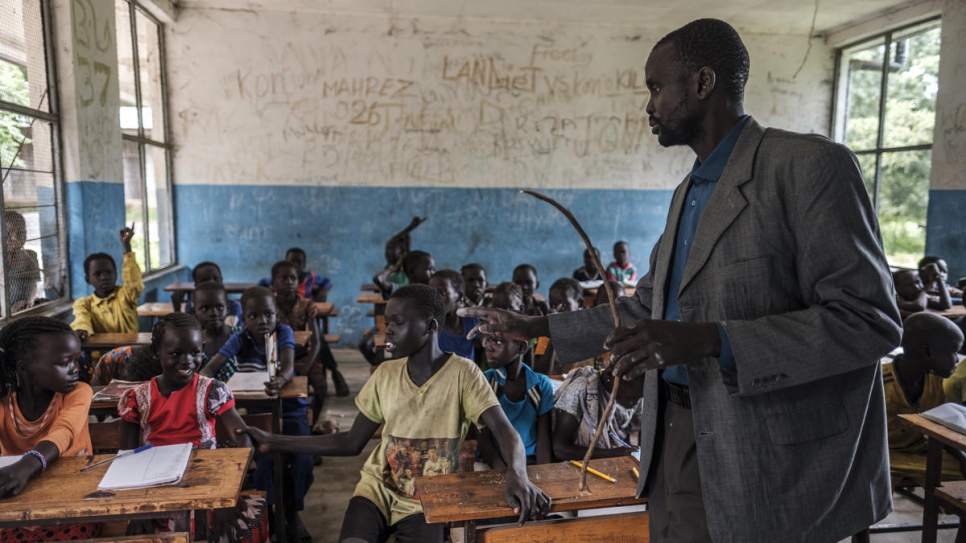 South Sudanese refugee James Tut teaches a primary school class in Jewi camp, Ethiopia.